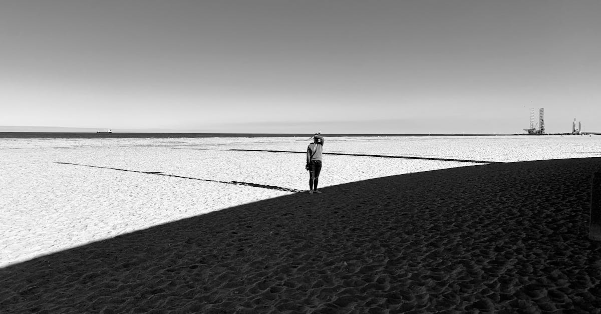 A person standing at a crossroads with multiple paths leading into a bright horizon, symbolizing choices and future.